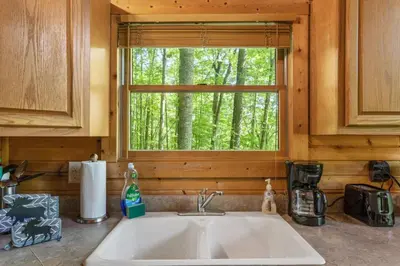 a kitchen counter with a sink and a window at Beary Secluded- No Pet Fee, Hot Tub, Firepit, WiFi in Slade