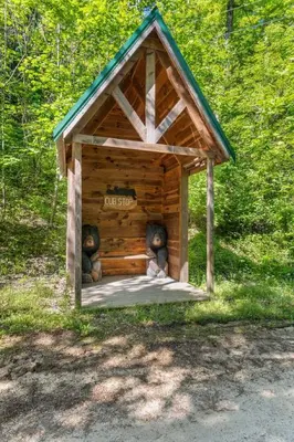 a small wooden out house with teddy bears in it at Beary Secluded- No Pet Fee, Hot Tub, Firepit, WiFi in Slade