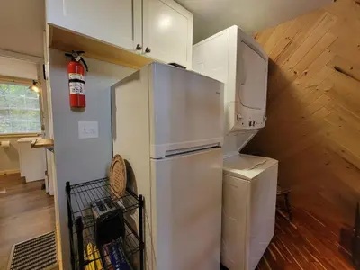 a kitchen with a refrigerator and a washer and dryer at A Frame of Mind - near Red River Gorge KY in Jeffersonville