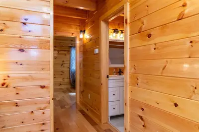 a log cabin with wooden walls and a closet at Cozy Canopy- Hot Tub, Firepit, Covered Deck, WiFi in Stanton