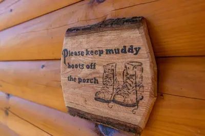 a sign on the side of a wooden wall at Cozy Canopy- Hot Tub, Firepit, Covered Deck, WiFi in Stanton