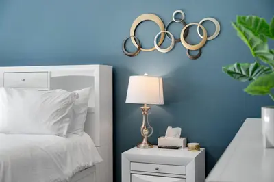 a bedroom with two olympic rings on a blue wall at Calaboose Retreat- Hot Tub , Pool Table, Fireplace in Campton