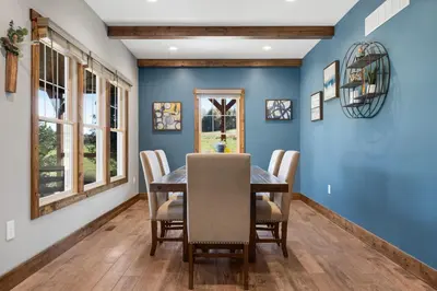 a dining room with blue walls and a table and chairs at Calaboose Retreat- Hot Tub , Pool Table, Fireplace in Campton
