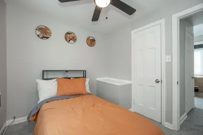 a bedroom with a bed and a ceiling fan at Cozy and stylish 3BR home in quiet neighborhood in Cleveland
