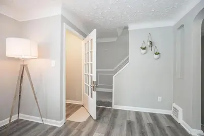 an empty room with a door and a lamp at Cozy and stylish 3BR home in quiet neighborhood in Cleveland