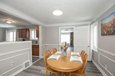 a dining room with a wooden table and chairs at Cozy and stylish 3BR home in quiet neighborhood in Cleveland
