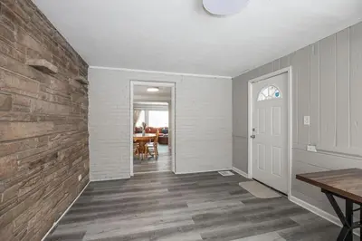 an empty room with a hallway with a wooden floor at Cozy and stylish 3BR home in quiet neighborhood in Cleveland