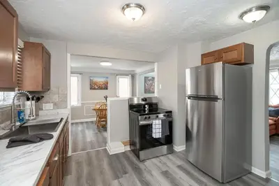 a kitchen with a stainless steel refrigerator at Cozy and stylish 3BR home in quiet neighborhood in Cleveland