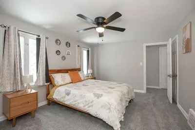 a bedroom with a bed and a ceiling fan at Cozy and stylish 3BR home in quiet neighborhood in Cleveland