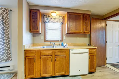 a kitchen with wooden cabinets and a sink and a window at Great for Families! Woodsy Hideaway in Decatur in Decatur