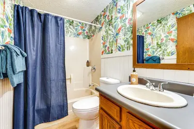 a bathroom with a sink and a toilet and a mirror at Great for Families! Woodsy Hideaway in Decatur in Decatur