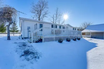 a house in the snow with the sun behind it at Great for Families! Woodsy Hideaway in Decatur in Decatur
