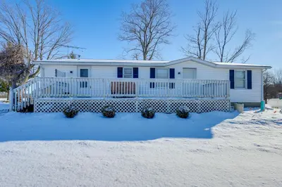 a white house with a porch in the snow at Great for Families! Woodsy Hideaway in Decatur in Decatur