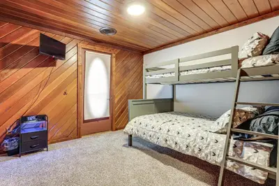 a bedroom with a bunk bed and a television at Woodburn Group Getaway Endless On-Site Fun! in Woodburn