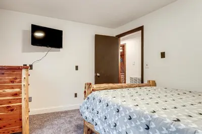 a bedroom with a bed and a tv on the wall at Woodburn Group Getaway Endless On-Site Fun! in Woodburn