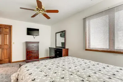 a bedroom with a bed and a ceiling fan at Woodburn Group Getaway Endless On-Site Fun! in Woodburn