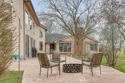 a patio with chairs and a table in front of a house at Woodburn Group Getaway Endless On-Site Fun! in Woodburn