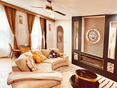 a living room with a couch and a fireplace at Downtown Cincinnati Boutique at Newport 3BR with 100in Cinema TV in Dayton