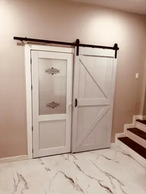 a white garage door in a room with marble floors at Downtown Cincinnati Boutique at Newport 3BR with 100in Cinema TV in Dayton
