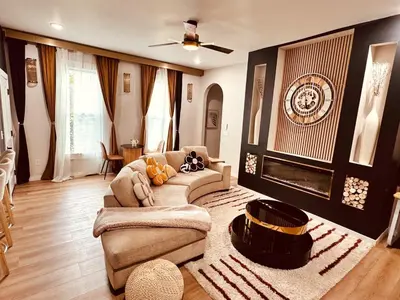a living room with a couch and a fireplace at Downtown Cincinnati Boutique at Newport 3BR with 100in Cinema TV in Dayton