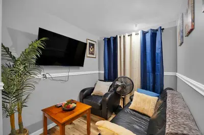 a living room with a couch and a tv at The Little Paradise in Morrow