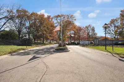 an empty road with an american flag on a pole at The Little Paradise in Morrow