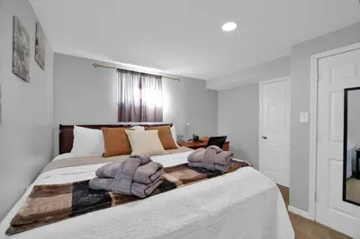 a bedroom with a large bed with blankets on it at The Little Paradise in Morrow