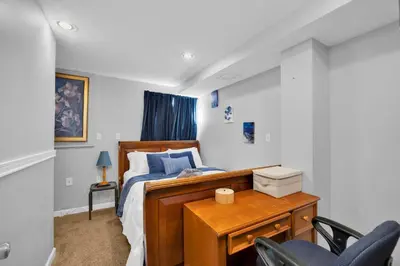 a bedroom with a bed and a desk with chairs at The Little Paradise in Morrow