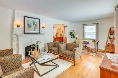 a living room with two couches and a fireplace at Bring the Family! Mid-Century Modern Gem in Euclid in Euclid