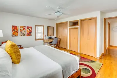 a bedroom with a large bed and a desk at Bring the Family! Mid-Century Modern Gem in Euclid in Euclid