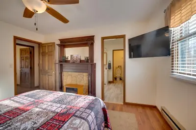 a bedroom with a bed and a flat screen tv at 5-Acre Hocking Hills Hideaway! Pet-Friendly Home in New Plymouth