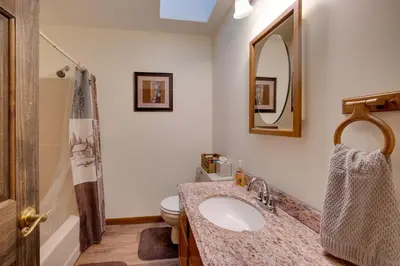 a bathroom with a sink and a toilet and a mirror at 5-Acre Hocking Hills Hideaway! Pet-Friendly Home in New Plymouth