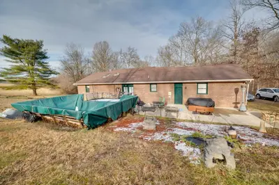 a house with a tarp on it in a field at 5-Acre Hocking Hills Hideaway! Pet-Friendly Home in New Plymouth