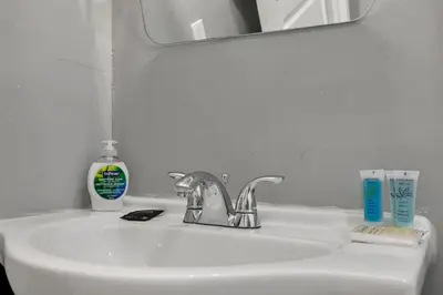 a bathroom sink with a toothbrush and toothpaste on it at Modern Columbus 2BR Near COSI & Arena District in Columbus