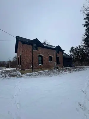 a brick building with snow in front of it at New Group Space - Sleeps 20! Near Sports Center in Huron