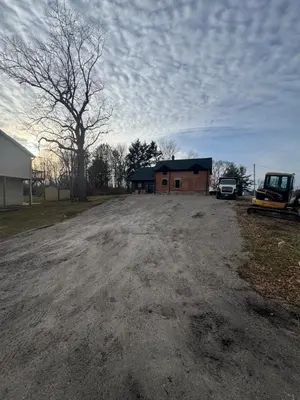 a dirt road with a building and a tree at New Group Space - Sleeps 20! Near Sports Center in Huron