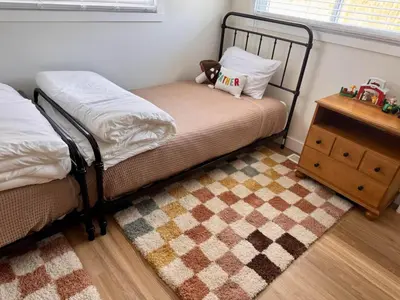 a bedroom with two beds and a teddy bear sitting on a bed at Logan’s Lookout over Mohican - Modern Farmhouse in Loudonville
