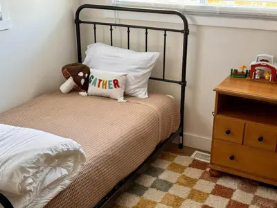 a bed with a teddy bear and a pillow on it at Logan’s Lookout over Mohican - Modern Farmhouse in Loudonville
