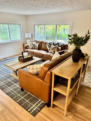a living room with a couch and a table at Logan’s Lookout over Mohican - Modern Farmhouse in Loudonville