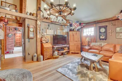 a living room with a couch and a tv at Dalton Retreat w Deck, Fire Pit and 6 Smart TVs in Dalton