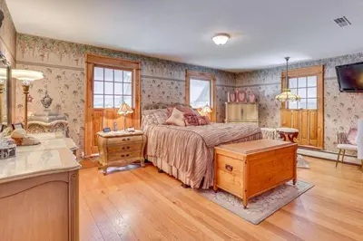 a bedroom with a bed and a dresser in it at Dalton Retreat w Deck, Fire Pit and 6 Smart TVs in Dalton