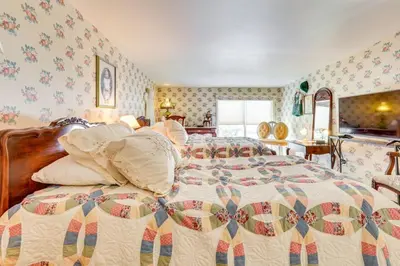 a bedroom with a bed with a quilt on it at Dalton Retreat w Deck, Fire Pit and 6 Smart TVs in Dalton
