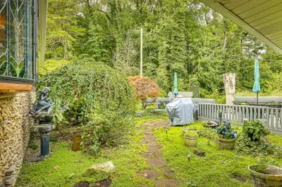 a garden with plants and a yard with a fence at Dalton Retreat w Deck, Fire Pit and 6 Smart TVs in Dalton