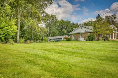 a large yard in front of a house at Dalton Retreat w Deck, Fire Pit and 6 Smart TVs in Dalton