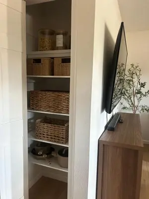 a room with a closet with baskets and a television at King suite and Hot Tub near the Greene in Dayton