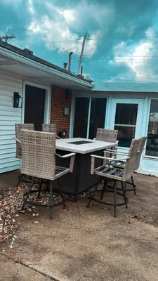 a table and chairs in front of a house at King suite and Hot Tub near the Greene in Dayton