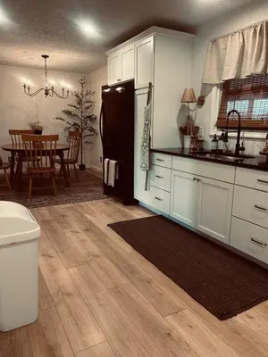 a kitchen with white cabinets and a black refrigerator at King suite and Hot Tub near the Greene in Dayton
