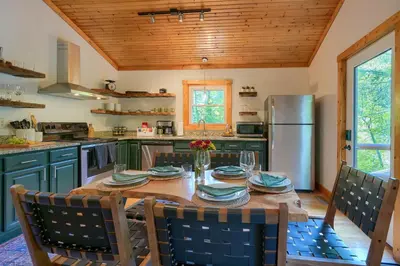 a kitchen with a table and chairs and a refrigerator at Havenwood in Logan