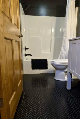 a bathroom with a toilet and a bath tub at Havenwood in Logan