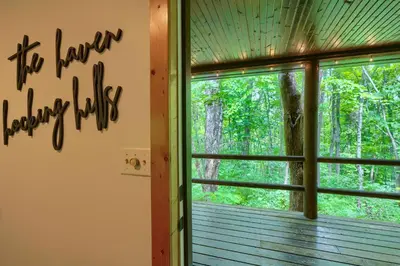 a room with a window looking out into the woods at Havenwood in Logan